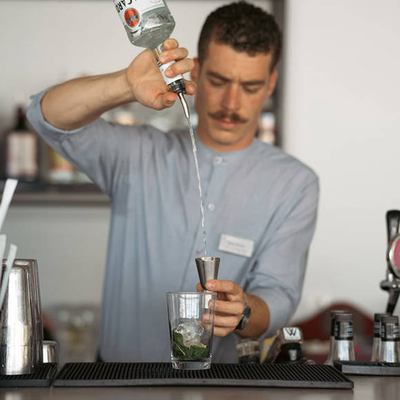 Bartender creating a cocktail at the hotel bar