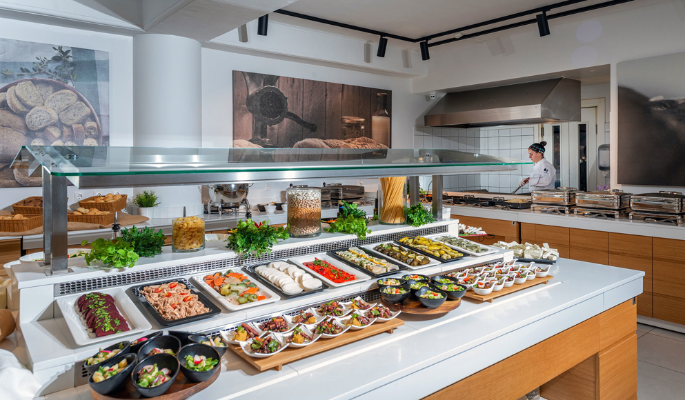 Buffet station with colorful cold dishes and appetizers