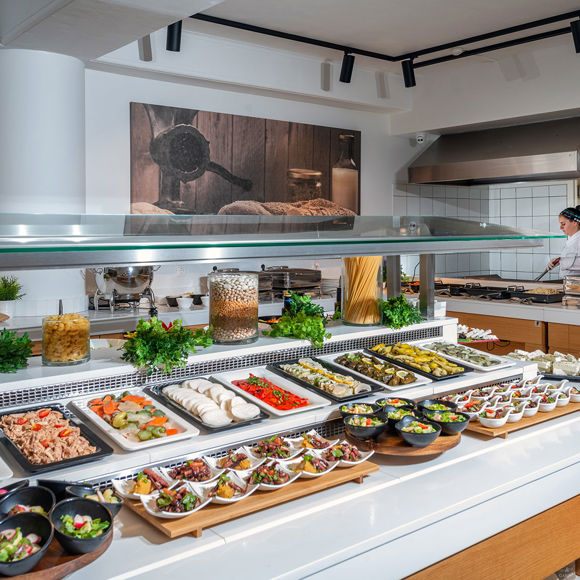 Buffet station with colorful cold dishes and appetizers