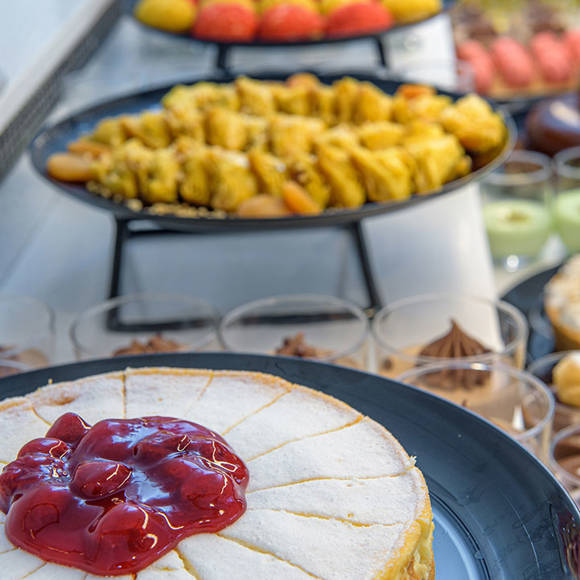 Close up of a cheesecake with assorted desserts in the background