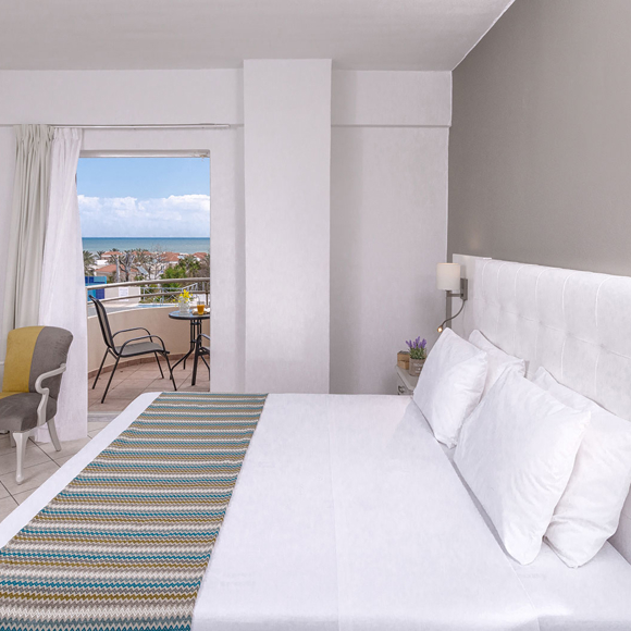 Double room with sea view balcony, modern decor and seating area