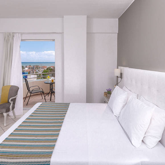 Double room with sea view balcony, modern decor and seating area
